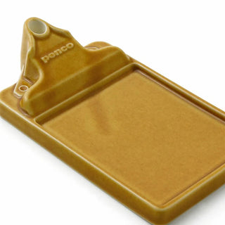 Brown ceramic incense holder close-up showing front ash tray and stick holder