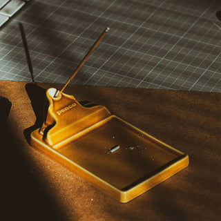 Brown ceramic incense holder with incense stick and rectangular ash tray