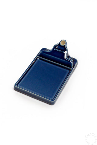 Navy ceramic incense holder tray with raised back rest and ring for incense stick.