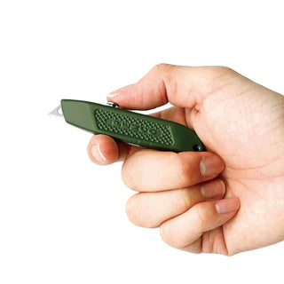 Pocket utility knife in olive green held in hand with lanyard chain