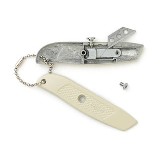 Pocket utility knife with ivory handle shown open, exposing the blade mechanism