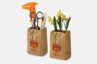 Two PENCO brown paper bag pen holders with stationery and small flowers