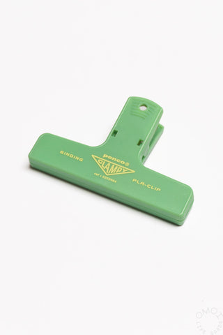 Green plastic binder clip with clamp arm