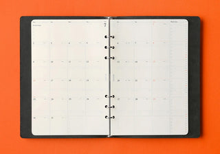 A5 monthly schedule 2027 refill inserted in ring binder, two calendar pages shown