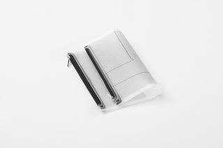 Light gray fastener case with perforated pockets and black strap, laid open