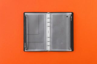 Light gray fastener case opened, two perforated pockets with dark side edges