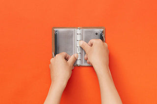 Fastener case mini-5, hands inserting into open gray mesh compartment