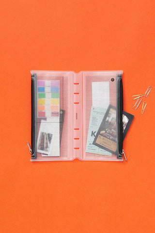 Open narrow fastener case with gray perforated pages and black side bands