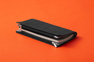 Closed narrow fastener case with black cover and metal latch hardware