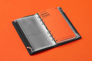 Open narrow fastener case with ring-style binder and gray perforated sheet