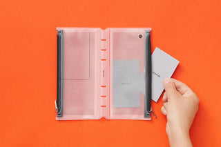 Open narrow fastener case with gray perforated pages, holding a card insert