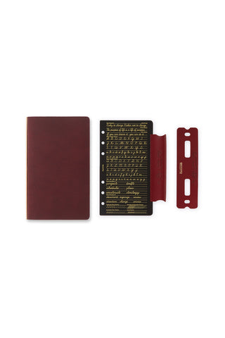 Red-brown leather binder with script insert and elastic bookmark strap
