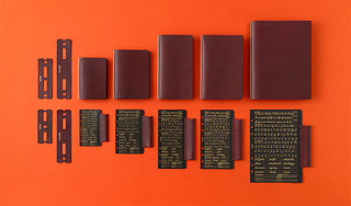 Red-brown mini-5 leather binder set with multiple covers and instruction cards