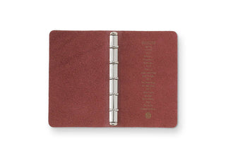 Red-brown leather binder closed with silver ring mechanism in the center
