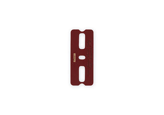 Red-brown leather binder spine with three punched slots and small engraved marks