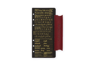 Narrow leather binder with red-brown cover and black insert with gold text