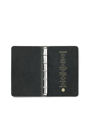 Black mini leather 5-ring binder open, showing metal rings and inner label
