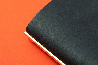 Black leather binder cover with textured finish and light spine edge