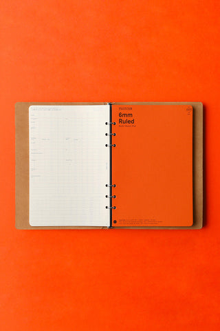 Beige A5 6-ring binder open, shows ruled pages with metal rings.