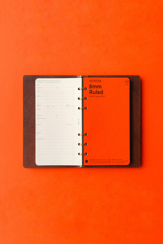 Brown leather 6-ring binder open with ruled inserts and metal rings
