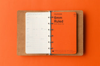 Beige mini leather 6-ring binder open with ruled pages