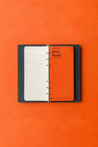 Navy narrow leather 6-ring binder open with ruled inserts