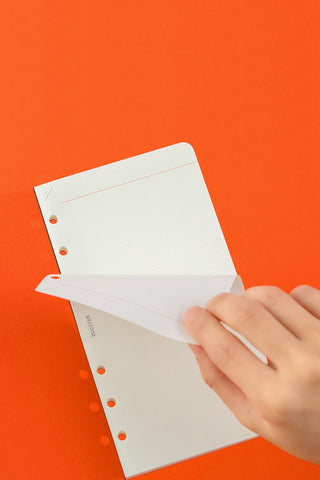 PLOTTER 2mm grid memo pad refill sheets with punched holes, held in hand