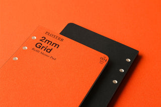 Black 2mm grid refill memo pad cover with orange label and punched side holes