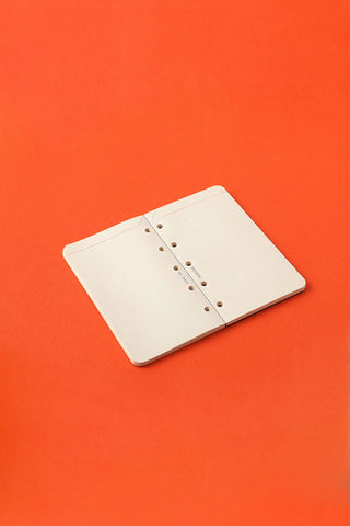 Mini-5 refill memo pad pages, white sheets with ring holes on a compact cover