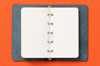 Refill memo pad with blue cover and white pages, five-ring binder center