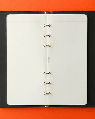 Open memo pad refill with white pages and brass ring binding