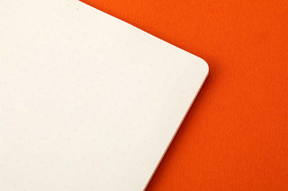 Corner detail of an A5 memo pad refill with a smooth white page edge