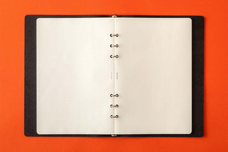 Open A5 memo pad refill with white pages and metal rings along the center binding