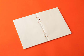 A5 memo pad refill opened with white pages and a punched line down the center