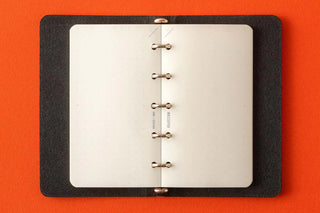 Memo pad refill inside clear binder with four metal rings and white dot-grid sheets