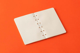 Open dot grid memo pad with punched holes and metal ring binding