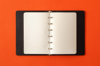 Open memo pad with black cover and metal ring binding for pages