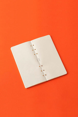 5mm dot grid memo pad refill, open pages with punched holes and binder spine