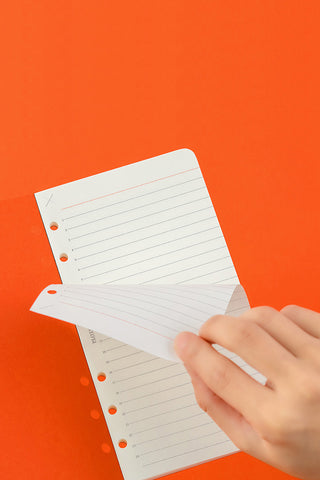 Ruled memo pad pages with 6mm lines and punched holes, open for writing