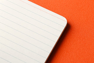 Rounded corner of white 6mm ruled memo pad refill, clean ruled lines on page