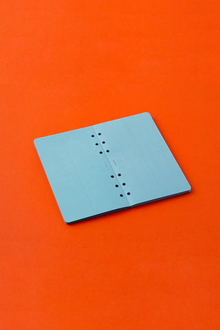 Blue memo paper pad with punched binder holes and 2mm grid lines