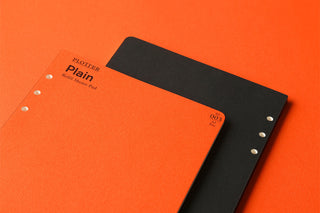 PLOTTER A5 plain memo pad refill, orange and black covers with punched hole strip.
