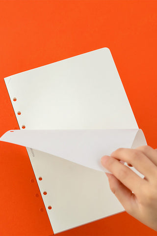 PLOTTER A5 plain memo pad refill, white pages with binder holes, partially opened.
