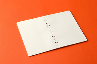 PLOTTER A5 plain memo pad refill, open white sheets with round binder holes along edge.