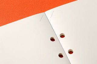 PLOTTER A5 plain memo pad refill pages, close-up of round binder holes.
