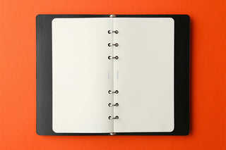 Refill memo pad opened flat, white pages with ring-style binder holes