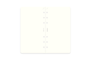 Closed refill memo pad with white inside pages and center spine holes