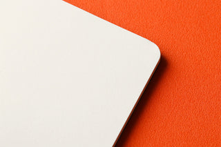 White memo pad page corner close-up with rounded edge