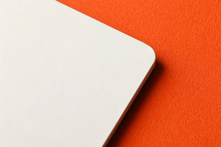 Corner of a white memo pad page with rounded edge
