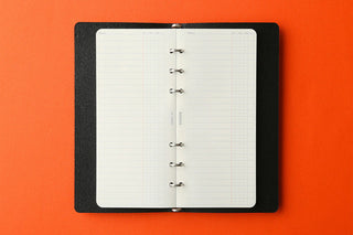 Open narrow To Do List refill memo pad in black holder with white grid pages